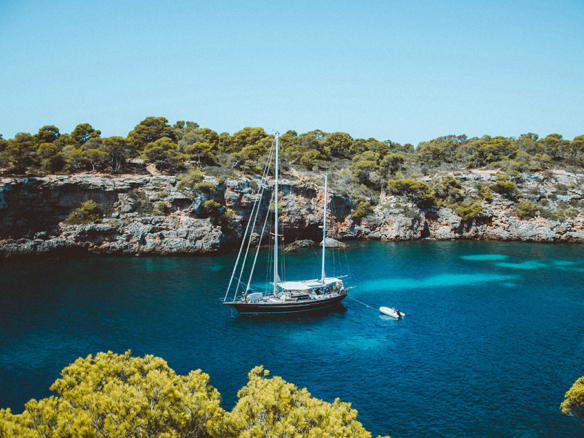 mallorca coastline with a luxury tall ship at anchor